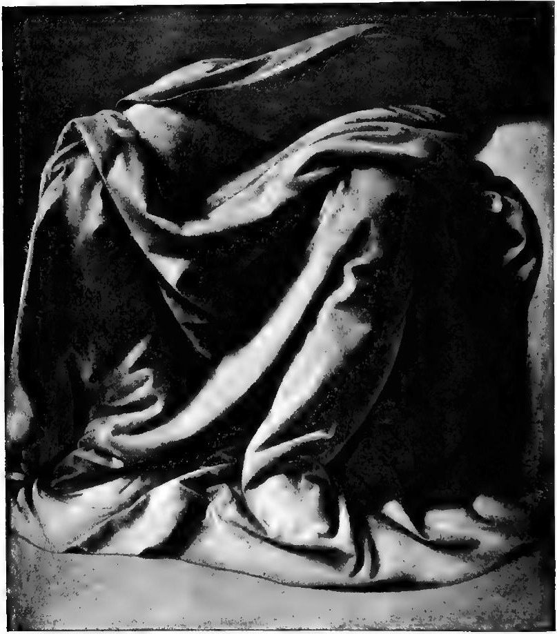 Reproduction of a drapery study by Leonardo da Vinci: heavy cloth falling in deep folds over a seated figure's knees, lit from the upper left, with the hollows in near-black shadow.