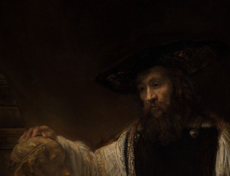 Detail of a bearded man in a dark hat, his face partly shadowed, resting one hand on a pale bust that catches the light.